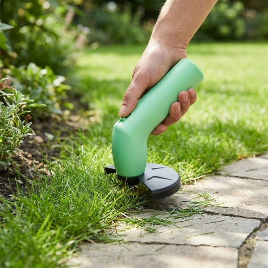 Cordless mini weed trimmer being used to trim grass edges in a yard