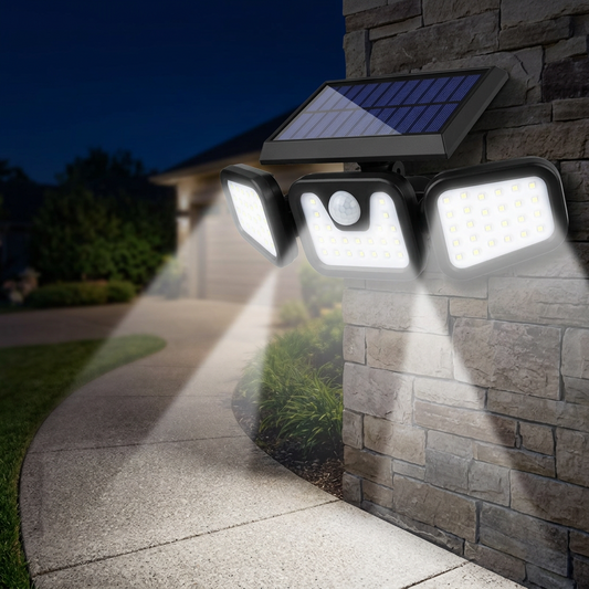 Motion sensor solar light mounted illuminating an outdoor wall at night
