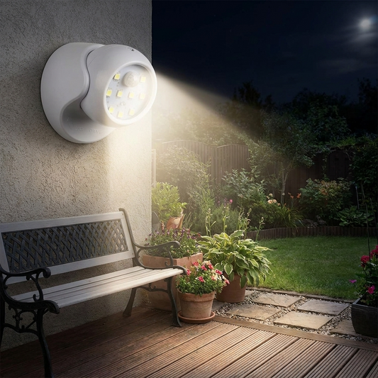 Wireless LED spotlight with motion detector illuminating a backyard at night