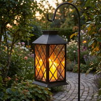 All weather garden hanging lantern hanging outdoors at dusk
