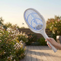 Person swatting a bug outdoors with a fast charging bug zapper racket
