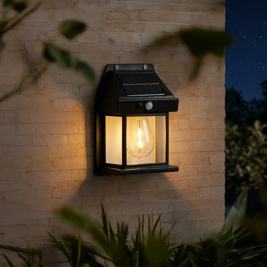 Outdoor solar LED light with motion sensor illuminating a house exterior wall at night
