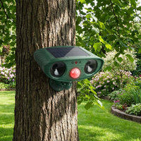 Ultrasonic woodpecker repellent mounted on a tree trunk