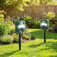 Advanced ultrasonic outdoor cat and dog deterrent staked in a backyard garden lawn