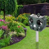 Solar ultrasonic animal repeller staked in a garden bed
