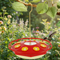 Hummingbird feeder hanging in a garden