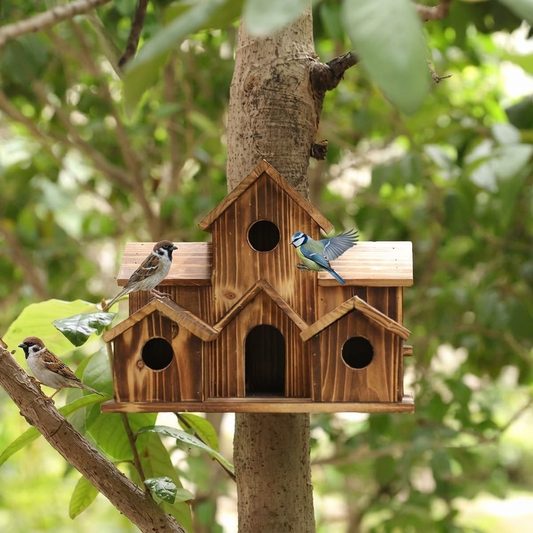 Wooden birdhouse mounted on a tree in a garden