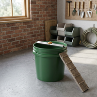 Roller mouse trap attached to a bucket in a garage