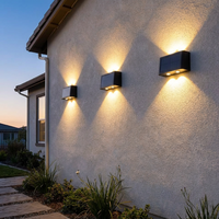 Solar wall light mounted on a house exterior at dusk