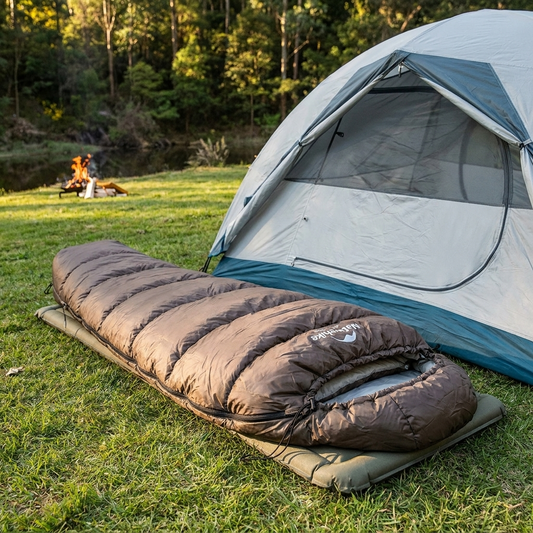 Sleeping bag laid out at an outdoor campsite