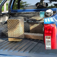 Cargo net secured over cargo in a pickup truck bed